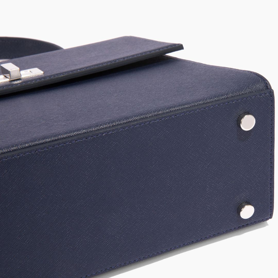 A close-up of the bottom panel of The She-EO handbag, showcasing its reinforced base with silver feet for added durability. Crafted from high-quality, sustainable cactus leather.