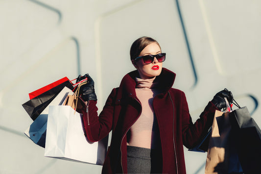 Stylish woman holding many shopping bags