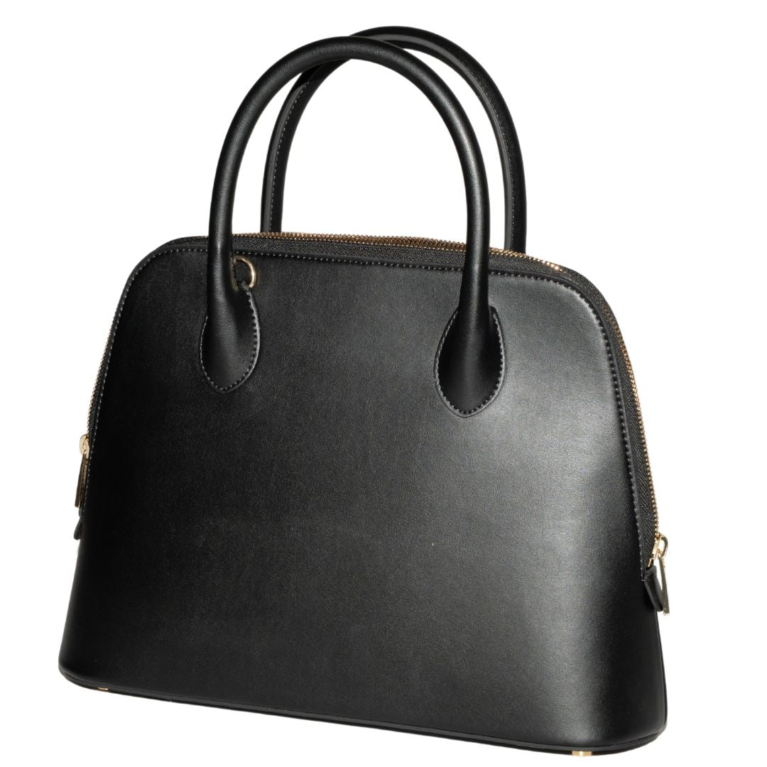A side-angle view of Ms. Lady Luck in Noir, showcasing its structured shape and smooth black grape leather. The handbag’s elegant curves and reinforced stitching highlight its durable craftsmanship and minimalist luxury.