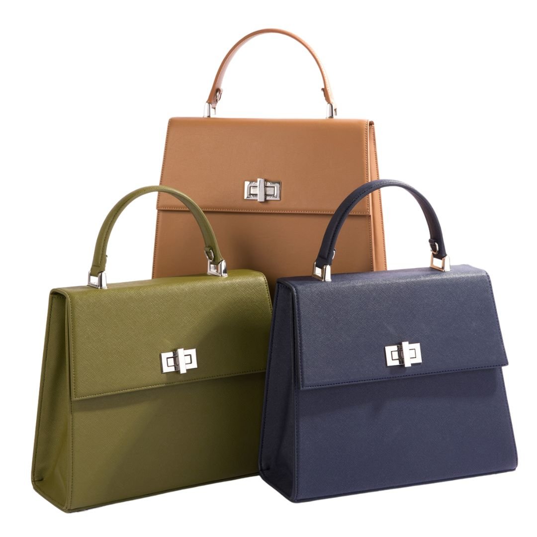 Three Carter Wade She-EO handbags in dark green, navy blue, and caramel, elegantly arranged to showcase their sophisticated boxy silhouette, sustainable craftsmanship, and cruelty-free, vegan materials handmade in New York City